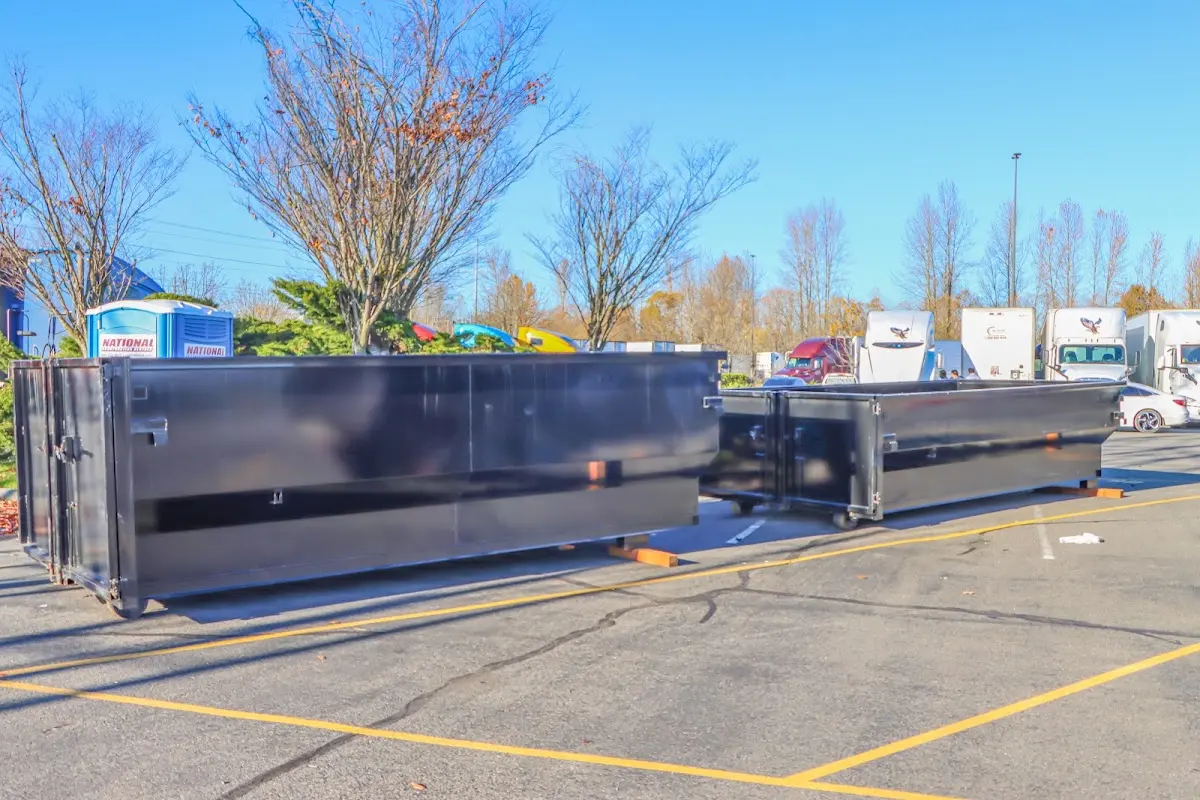 Professional dumpster rental service with roll-off container on residential driveway in Rumford